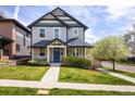A charming two-story home with a welcoming blue front door and a beautifully landscaped front yard at 3504 Newton St, Denver, CO 80211