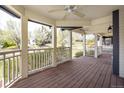 Inviting covered porch with wood flooring, white railings, and serene neighborhood views at 3504 Newton St, Denver, CO 80211