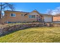 Charming brick home featuring a front yard with stone accents, and mature landscaping at 3570 W Pimlico Ave, Englewood, CO 80110