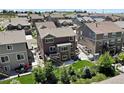 Aerial view of a backyard with a patio, lush lawn, mature trees, and privacy fence at 20855 Park Hollow Dr, Parker, CO 80138