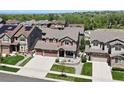 Aerial view of a two-story home with a three-car garage and a beautifully landscaped front yard at 20855 Park Hollow Dr, Parker, CO 80138