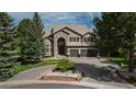 Beautiful home with stone accents, a three-car garage, and a meticulously maintained front yard at 171 October Pl, Castle Rock, CO 80104