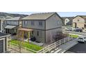 Backyard of a gray two-story home with pergola and a white wooden fence at 2688 Loon Cir, Castle Rock, CO 80104