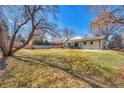 Expansive backyard featuring a spacious lawn, privacy fence, and a patio area perfect for outdoor entertaining at 3680 S Glencoe St, Denver, CO 80237