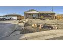 Charming brick home with a well-maintained front yard and a detached garage at 7217 Huron St, Denver, CO 80221