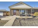 Inviting covered front porch with seating area, perfect for relaxing outdoors at 7217 Huron St, Denver, CO 80221