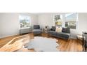 Bright living room with hardwood floors, large windows, and contemporary furniture at 1615 S Elizabeth St, Denver, CO 80210