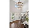 Grand entryway featuring soaring ceilings, elegant chandelier, hardwood floors, and staircase, creating a welcoming ambiance at 11453 E Orchard Pl, Englewood, CO 80111