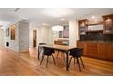 Elegant dining room with a modern table and chairs, custom cabinets, and hardwood flooring at 1411 Wynkoop St # 804, Denver, CO 80202