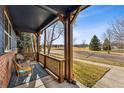 Inviting front porch with comfortable seating, offering a relaxing outdoor space and neighborhood views at 2412 Windmill Dr, Longmont, CO 80504