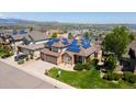 Beautiful aerial view of a home with solar panels, lush landscaping, and a picturesque neighborhood setting at 58 Rogers Ct, Golden, CO 80401