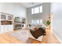 Bright living room with fireplace, hardwood floors, high ceiling, and neutral decor for a comfortable space at 58 Rogers Ct, Golden, CO 80401