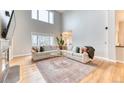Bright living room featuring vaulted ceilings, large windows, and hardwood floors providing an open and inviting space at 58 Rogers Ct, Golden, CO 80401