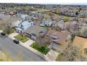Expansive aerial view of a residential neighborhood showcasing various home styles and green spaces at 5133 S Liverpool Way, Centennial, CO 80015