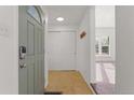 Inviting entryway with tile flooring, coat closet, and natural light flowing into the home at 3300 W 2Nd Ave, Denver, CO 80219