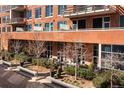 Exterior of an apartment building with well-maintained landscaping, including trees and planters, offering outdoor living space at 100 Detroit St # 103, Denver, CO 80206