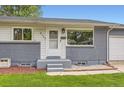 Charming home showcasing a front entrance with painted brick accents and well-maintained landscaping at 5150 W Colgate Pl, Denver, CO 80236