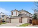 Inviting two-story house featuring a three-car garage, neutral siding, and a well-manicured lawn at 6459 S Queen Way, Littleton, CO 80127