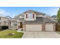 Beautiful home with an attached three-car garage and traditional architectural details at 6459 S Queen Way, Littleton, CO 80127