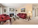 Inviting living room features a cozy fireplace, large windows, and comfortable seating, perfect for relaxing and entertaining at 8094 E Kenyon Pl, Denver, CO 80237