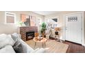 Cozy living room with brick fireplace, natural light, and stylish decor at 4344 Wyandot St, Denver, CO 80211