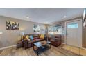 Inviting living room with wood floors, brown sofa, natural light, and cozy decor at 3282 W 66Th Ave, Denver, CO 80221