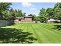 Expansive lawn and beautiful landscaping surround this charming home at 1380 Holly E Dr, Broomfield, CO 80020