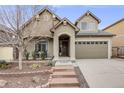 Inviting home exterior showcases a covered front porch and neatly landscaped yard leading to the attached two-car garage at 3502 First Light Dr, Castle Rock, CO 80109
