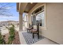 Comfortable front porch boasts an inviting seating area, perfect for relaxing outdoors and enjoying neighborhood views at 3502 First Light Dr, Castle Rock, CO 80109