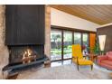 Bright living room featuring a fireplace, large windows, and a view of the outdoor landscape at 3650 Chimayo Rd, Littleton, CO 80123