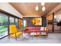 Well lit living room showcasing contemporary furnishings and a view to the outdoors at 3650 Chimayo Rd, Littleton, CO 80123