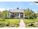 Charming single-story home with manicured front yard landscaping and a stone walkway leading to the front door at 1185 Glencoe St, Denver, CO 80220