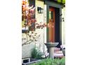 Close-up of a home's front door and entry, complete with an elegant water fountain and well-maintained landscaping at 1185 Glencoe St, Denver, CO 80220
