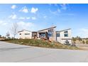 Contemporary house exterior, showcasing a sleek design and landscaping at 10205 Inspiration Dr, Parker, CO 80138