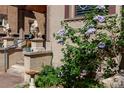 Home's entrance featuring stone lion statues, detailed brickwork, and lush flowering plants at 1022 N Pearl St # 101, Denver, CO 80203