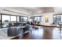Bright living room with floor-to-ceiling windows offering panoramic city views and dark wood flooring at 1133 14Th St # 3320, Denver, CO 80202