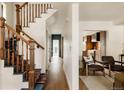 Inviting foyer featuring hardwood floors, a staircase with decorative runners, and access to a modern kitchen at 940 N Ogden, Denver, CO 80218