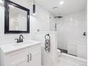 Modern bathroom with white marble tiles, a glass-enclosed shower, and a vanity with a sink at 800 N Pearl St # 1203, Denver, CO 80203