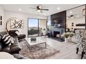 Cozy living room with a black fireplace, plush seating, and a sliding glass door to the balcony at 800 N Pearl St # 1203, Denver, CO 80203