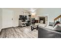 Spacious living room with wood floors, a brick fireplace, and a comfortable seating area at 1946 Ensenada St, Aurora, CO 80011