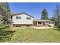 Well-maintained home featuring brick and siding, set on a green lot with mature trees at 15065 Huron St, Broomfield, CO 80023