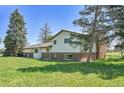 Rear exterior view highlighting the home's architecture and spacious backyard at 15065 Huron St, Broomfield, CO 80023