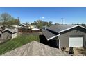 Aerial backyard view of a well-maintained yard, a shop building, and mature trees at 504 Elizabeth Ave, Platteville, CO 80651