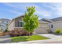 Lovely single-story home boasting stone accents, lush lawn, and a two-car garage at 21893 E Tufts Cir, Aurora, CO 80015