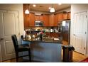 Well-appointed kitchen featuring granite countertops, stainless steel appliances, and breakfast bar seating at 12714 Leyden St # C, Thornton, CO 80602