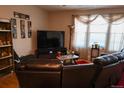 Comfortable living room with large windows, modern entertainment setup, and stylish decor at 12714 Leyden St # C, Thornton, CO 80602