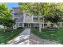 Well-maintained condo building with meticulous landscaping, a walkway and bench seating, inviting guests and residents alike at 3144 S Wheeling Way # 106, Aurora, CO 80014