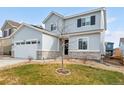 Two story home with attached garage and landscaped yard at 9392 Anvil St, Arvada, CO 80007