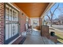 Inviting covered front porch featuring brick pillars and a decorative security door at 772 Garfield St, Denver, CO 80206