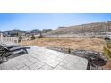 Spacious backyard with a stone patio, offering peaceful views of the surrounding area at 5381 Hickory Oaks Trl, Castle Rock, CO 80104